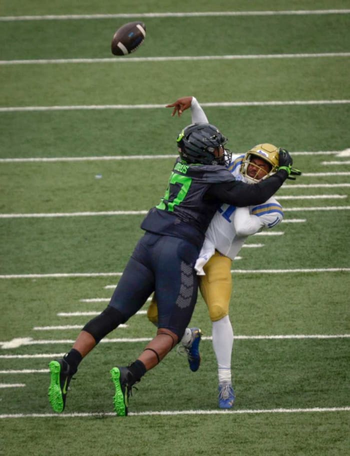 Brandon Dorlus rocks quarterback Chase Griffith late in the second quarter against UCLA. Dorlus' hit forced an interception that helped Oregon gain a slim lead going into halftime.
